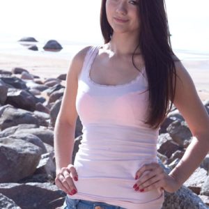 Petite brunette amateur Olivia displaying pointy teener breasts outdoors on rocky beach