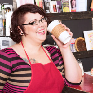 Redheaded fatty Kitten McPherson sports short hair and glasses while getting naked in a diner