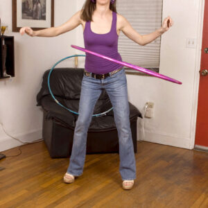 Dark haired nubile Ann Parker works a hula hoop before getting fully nude while fucking