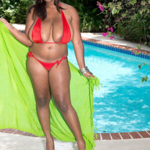 Chunky black MILF Marie Leone looses her big tits from a red bathing suit in a swimming pool