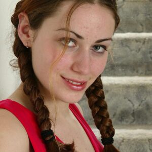 First timer in braided pigtails displays her tiny tits and natural pussy