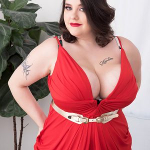 Tattooed fatty Nagini takes off a red sundress while making her nude debut