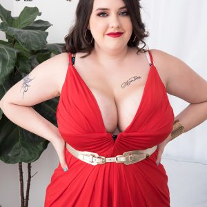 Tattooed fatty Nagini takes off a red sundress while making her nude debut