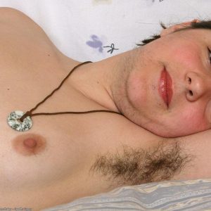 Hairy European first-timer demonstrating hairy underarms and natural cunt on bed